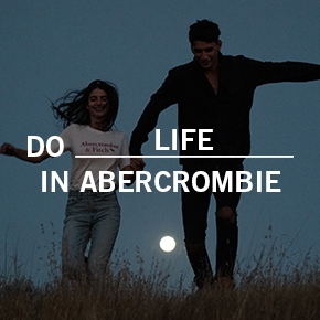 Do life in Abercrombie. Man and woman holding hands in a field at night.